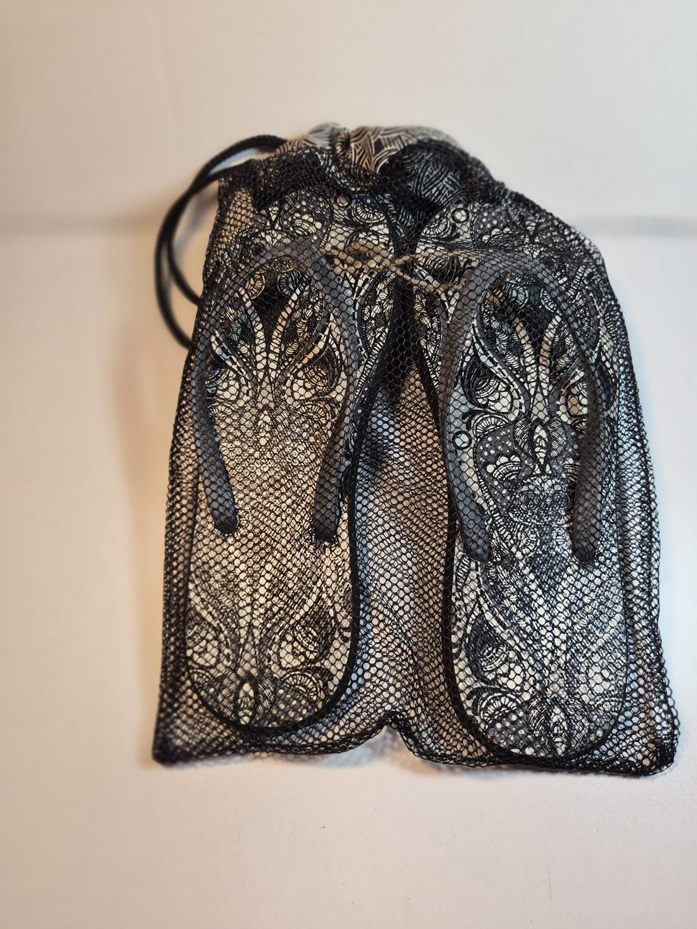 Sakroot Black Lace Flip Flops in Mesh Drawstring Bag